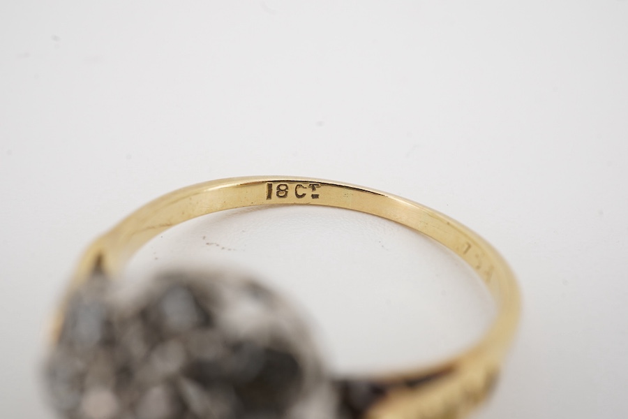An 18ct and illusion set diamond cluster ring, size M/N, gross weight 3.6 grams. Condition - fair